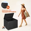 A woman walks past an open storage box, carrying a pillow. Produktbild-Vorschau