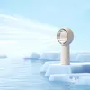 A beige handheld fan emitting a stream of white air, placed on an iceberg in a blue, watery environment. Anteprima dell’immagine prodotto