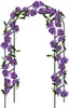 A metal garden arch covered in purple flowers and green leaves, set against a white background. Podgląd zdjęcia produktu