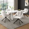 A dining room set with a marble-top table and four beige upholstered chairs with black metal legs. Produktbild-Vorschau