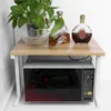 A two-tier shelf unit with a microwave on the bottom and decorative items on top. Voir les images du produit