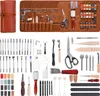 A collection of leatherworking tools laid out on a white background, with a rolled-up leather storage case on the left. Produktbild-Vorschau