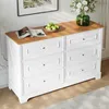 A white dresser with a wooden top, decorated with a bowl of green apples, a book, and a vase of flowers. Anteprima dell’immagine prodotto