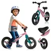 A young boy wearing a helmet rides a pink balance bike. Produktbild-Vorschau