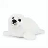 A white plush seal toy is lying on a white background. Produktbild-Vorschau