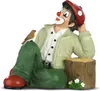 A figurine of a clown sitting with a bird on its knee. Produktbild-Vorschau