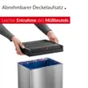 Hands are shown removing a black lid from a silver trash can with a blue trash bag inside. Produktbild-Vorschau
