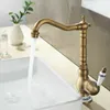 A vintage-style faucet with water running into a white sink. Náhľad obrázku produktu