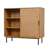 A wooden cabinet with a rattan front and black legs, shown against a white background. Produktbild-Vorschau