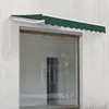 A dark green awning is extended over a large window on a textured light gray wall. Anteprima dell’immagine prodotto