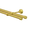 A close-up view of a double curtain rod in a brass gold finish, mounted against a white background. Anteprima dell’immagine prodotto