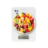 A digital kitchen scale with a bowl of fruit salad on it. Produktbild-Vorschau