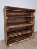 A wooden crate shelf unit against a white wall and wooden floor. Náhled obrázku produktu