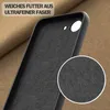 Close-up view of the interior of a black phone case, showing its soft lining, with a magnified inset of the lining texture. The background is a textured brown fabric. Produktbild-Vorschau