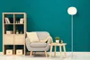 A living room scene with a bookshelf, armchair, and floor lamp. Produktbild-Vorschau