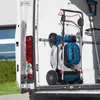 A Bosch lawnmower and trimmer are stored inside the back of a white van. Voir les images du produit