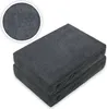 A close-up view of two folded dark grey fitted sheets stacked on top of each other, with a circular inset showing a magnified view of the fabric texture. Produktbild-Vorschau
