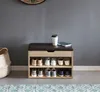 A shoe bench with storage and a padded seat is shown in a room with a gray wall and a patterned rug. Náhľad obrázku produktu
