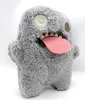 A plush toy monster with a pink tongue sticking out, set against a white background. Produktbild-Vorschau