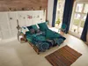 A bedroom scene with a bed made with a mandala and leopard print duvet cover, set on a pallet bed frame. Produktbild-Vorschau