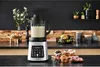 A kitchen counter with a blender, muffins, and donuts. Voir les images du produit