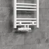 A white radiator valve set is mounted on a gray tiled wall. Náhled obrázku produktu