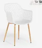 A white modern design polypropylene chair with armrests and wooden legs, shown against a white background. Several other chairs in different colors are visible in the upper right corner. Produktbild-Vorschau