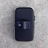 A black bicycle or motorcycle phone holder is placed on a concrete surface. Voir les images du produit