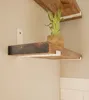 Two wooden shelves mounted on a wall with white brackets. A small plant in a pot is on the upper shelf. Produktbild-Vorschau