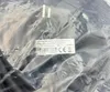 A close-up of a product in plastic packaging, showing a label with technical specifications and certifications. Produktbild-Vorschau