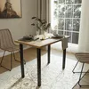 A dining table set up in a room with a window and chairs. Produktbild-Vorschau