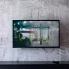 A TV mounted on a concrete wall, displaying a sports event. Podgląd zdjęcia produktu