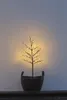 A small LED tree in a pot is placed on a dark surface against a light-colored wall. Produktbild-Vorschau