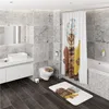 A modern bathroom with marble-tiled walls and dark wood-plank flooring, featuring a toilet, sink, and bathtub. A shower curtain and bath mat with a cat design are prominently displayed. Produktbild-Vorschau