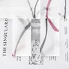 A close-up view of a sheer curtain with a floral pattern and text details. Produktbild-Vorschau