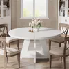 A round dining table with chairs in a dining room setting. Náhľad obrázku produktu