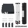 A collection of items laid out on a white background, including a folded dark gray fabric, tent poles, ropes, stakes, and weight bags, along with a black carrying bag. Produktbild-Vorschau