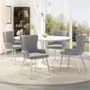 A dining room setting with a round table and four chairs. Produktbild-Vorschau