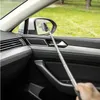 A person is using a telescopic cleaning tool to clean a car's side mirror from inside the car. Anteprima dell’immagine prodotto