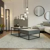 A modern living room with a sectional sofa, coffee tables, and decorative lighting. Produktbild-Vorschau