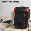 A black and red power tool battery is shown in the foreground, with wooden planks and some tools in the background. Náhled obrázku produktu
