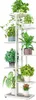 A white metal plant stand with multiple tiers, holding various potted plants. Náhľad obrázku produktu