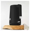 A black electric kettle sits on a wooden board. Náhľad obrázku produktu