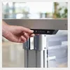 A hand is pressing buttons on a desk control panel. Produktbild-Vorschau