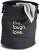 A dark gray laundry basket with the words "live. laugh. love." printed on it in a light color. A gray towel is draped over the edge of the basket. Podgląd zdjęcia produktu