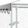Close-up view of a section of an outdoor dog kennel, showing the roof edge, wire mesh fencing, and support posts with a latch mechanism. Voir les images du produit