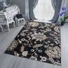 A rug with a classic floral pattern is placed on a wooden floor in a room with a white dresser and grey curtains. Náhled obrázku produktu