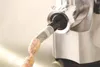 A close-up shot of a meat grinder producing sausages. Podgląd zdjęcia produktu