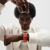 A person wearing a smartwatch is shown against a white background. Voir les images du produit