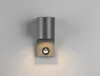 A modern wall lamp mounted on a light gray wall. Produktbild-Vorschau